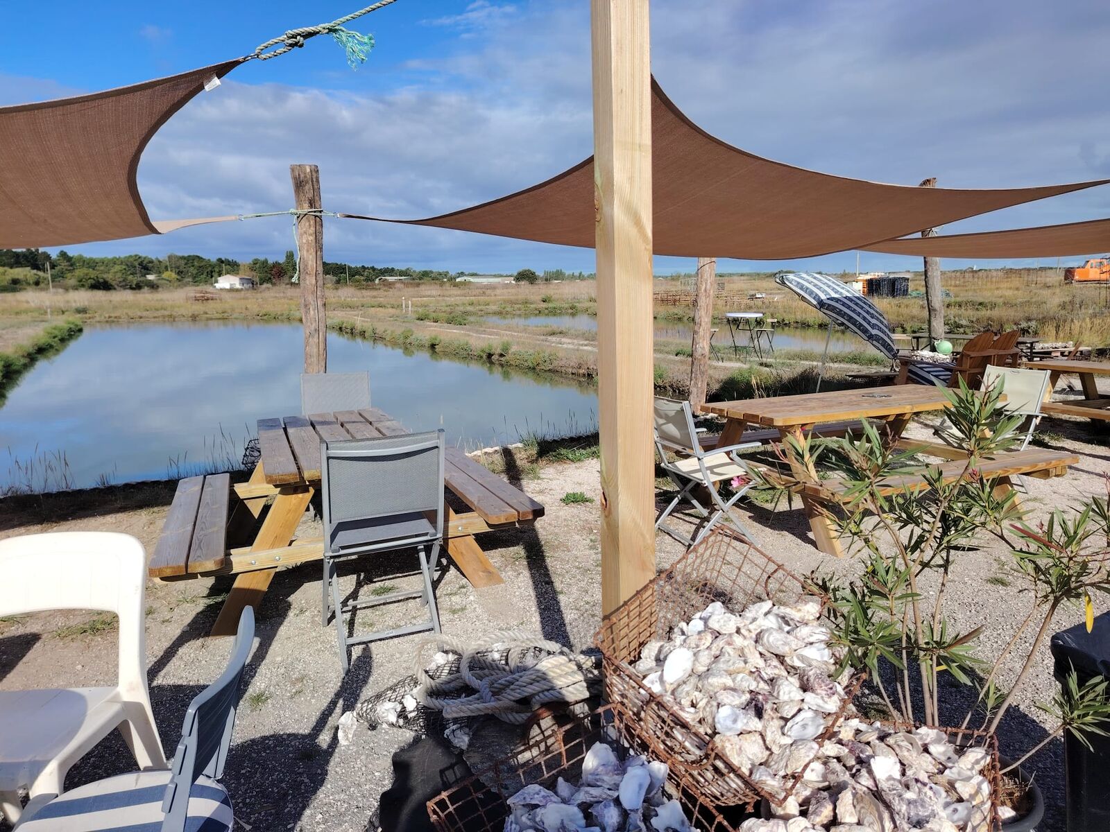 La terrasse de la cabane sous les voiles d'ombrage, face aux claires